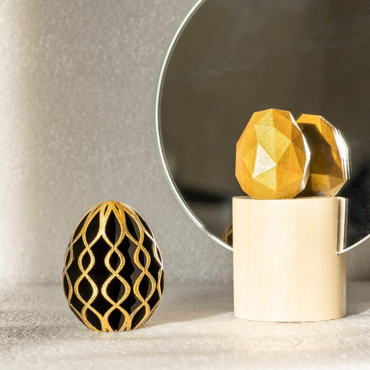 Trendy Easter low poly decor. Golden and black eggs of geometric style. Happy Easter greeting card. Holiday concept in minimal style.